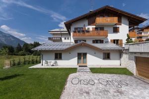 a large white house with a balcony on top of it at Junior Suite Orso Grigio in Andalo