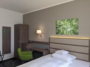 Säng eller sängar i ett rum på Parkhotel am Taunus