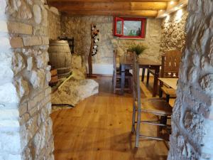 a dining room with a table and a stone wall at come prima in Ausonia