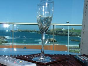 a wine glass sitting on top of a table at Apartamentos Maradentro in Soto de la Marina
