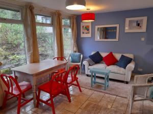 a living room with a table and chairs and a couch at Blue Skies in St Ives