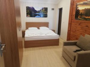 a small bedroom with a bed and a couch at şerah bungawilla in Uzungöl