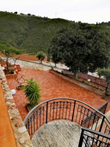 a bridge over a red brick walkway in a park at Villa Verde in Cefalù