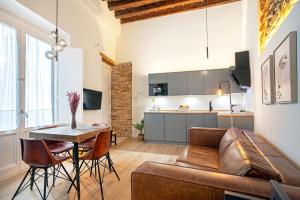 a living room with a couch and a table at Genteel Home Plaza de España Cádiz in Cádiz