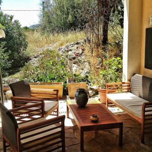 a patio with chairs and a table with a vase on it at auberge de tesa in Occhiatana