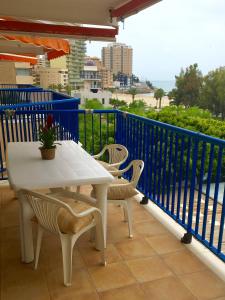 a white table and chairs on a balcony at Apartamentos Palmavera in Oropesa del Mar