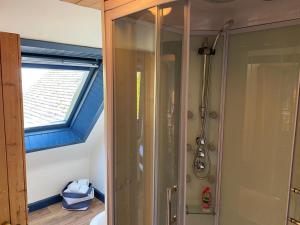 a bathroom with a shower and a window at Lamlash- Self catering accommodation with seaviews in Lamlash