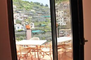 a view of a balcony with tables and chairs at Villa Anna in Minori