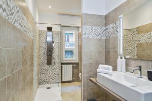 a bathroom with a sink and a shower at Carignano Design Apartments by Wonderful Italy in Genoa