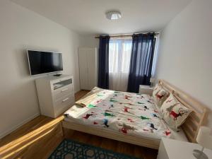 a small bedroom with a bed and a flat screen tv at Bendida Central in Velingrad