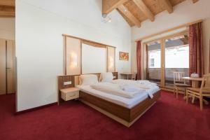 En eller flere senge i et værelse på Hotel Abendrot by Alpeffect Hotels