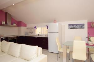 a living room with a white couch and a table at Apartments Korčula in Prizba +31 photos
