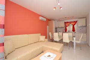 a living room with a couch and a kitchen at Apartments Korčula in Prizba