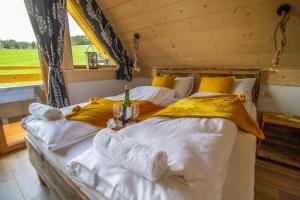 a bedroom with two beds with yellow and white sheets at EM Gorce Resort in Waksmund