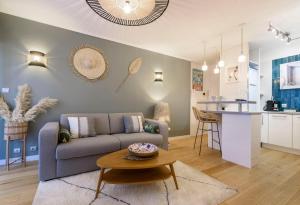 a living room with a couch and a table at Host Inn Sweet Croisette in Cannes
