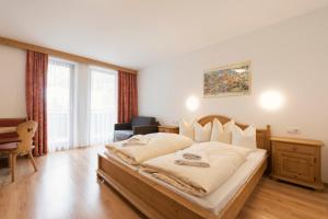 a bedroom with a large bed in a room at Hotel Gabl by Alpeffect Hotels in Sankt Anton am Arlberg