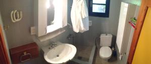 a small bathroom with a sink and a toilet at Secluded 1.8 acre garden Villa, for exclusive use with Stunning Views. in Kalandra +32 photos