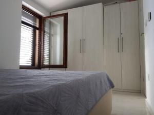 a bedroom with a bed and a large window at Relax Zone III in Malinska