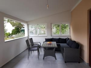 a living room with a couch and a table at Relax Zone III in Malinska