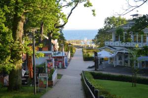 a street in a town with the ocean in the background at Appartementanlage Villa Granitz 45 in Göhren