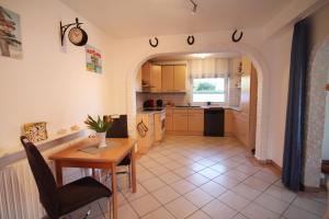 a kitchen with a table and a dining room at Haus Clara in Husby