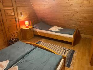 a room with two beds in a wooden cabin at Sikaszoi vizimalom in Sicasău +22 photos