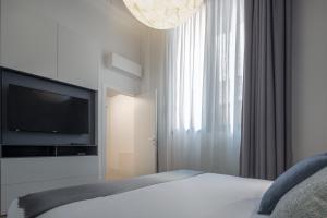 A bed or beds in a room at Fornace Loft with Dependance R&R
