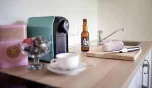 a bottle of beer and a cup on a kitchen counter at Berghof Seiser Toni in Oberhöflein