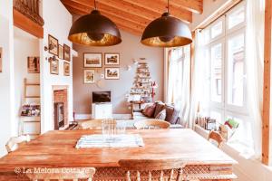 a dining room with a table and a christmas tree at La Melosa Cottage in Cudillero