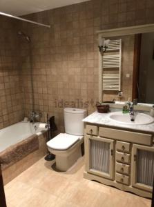 a bathroom with a toilet and a tub and a sink at Apartament de Luxe a Port del Comte in La Coma i la Pedra