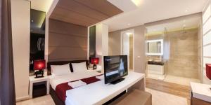 En eller flere senger på et rom på Eden Garden Suites