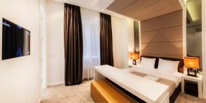 En eller flere senger på et rom på Eden Garden Suites