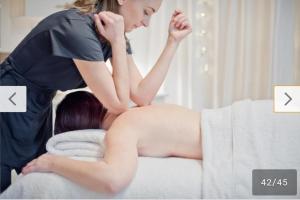 a woman laying on a bed with a woman standing on top at T3 duplex malibu village pass piscine en supplément 2 a 8 personnes in Canet-en-Roussillon