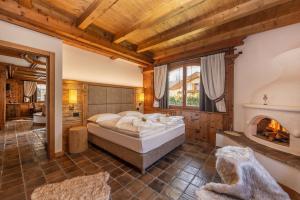 a bedroom with a bed and a fireplace at Chalet Mountain Plaza - Apt Garden in Pinzolo