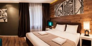 En eller flere senger på et rom på Eden Garden Suites