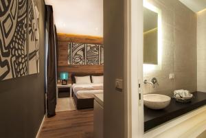 En eller flere senger på et rom på Eden Garden Suites