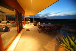 a patio with a table and chairs on a house at Almonta Park Lodge in Coffin Bay