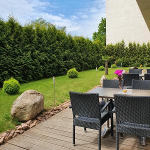 a patio with a table and chairs and a rock at Hotel Atlas Halle in Halle an der Saale