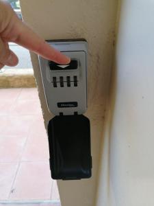 a hand pointing at an electrical outlet on a wall at Calme et arboré, Studio 34 in Digne-les-Bains