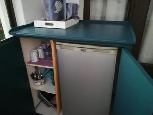 a blue counter top on top of a refrigerator at Trev's Place in St Francis Bay