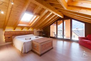 a bedroom with a large bed in a room with wooden ceilings at Il Grifo in Lenno