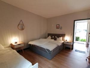 a bedroom with a large bed and two night stands at Waldjugendherberge Uelsen in Uelsen