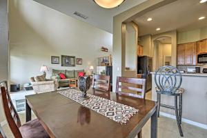 a kitchen and living room with a wooden table and chairs at Golf Course View and Pool Access Gold Canyon Gem in Gold Canyon