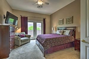 a bedroom with a bed and a tv and a chair at Golf Course View and Pool Access Gold Canyon Gem in Gold Canyon +29 photos