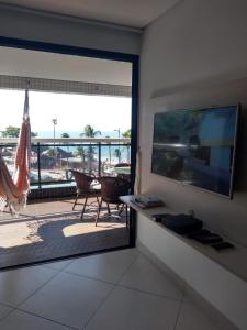 a living room with a large sliding glass door to a patio at Alugo Temporada apartamento frente ao mar de Fortaleza vista panorâmica do Mar in Fortaleza