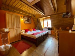a bedroom with a bed in a wooden room at Vila Viktoria in Štôla