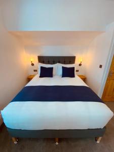 a bedroom with a large bed with blue pillows at Self Contained Guest suite 2 - Weymouth in Weymouth