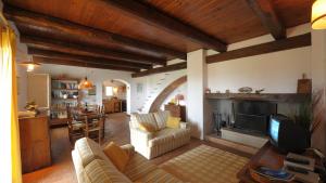 a living room with a couch and a fireplace at CASALE SALLY 6, Emma Villas in Baschi