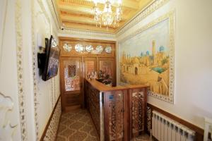 a hallway with a painting on the wall at Xadijam Hotel in Bukhara