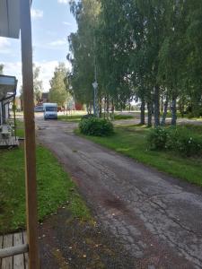 an empty road with a van parked on the side at majoitus in Alavieska